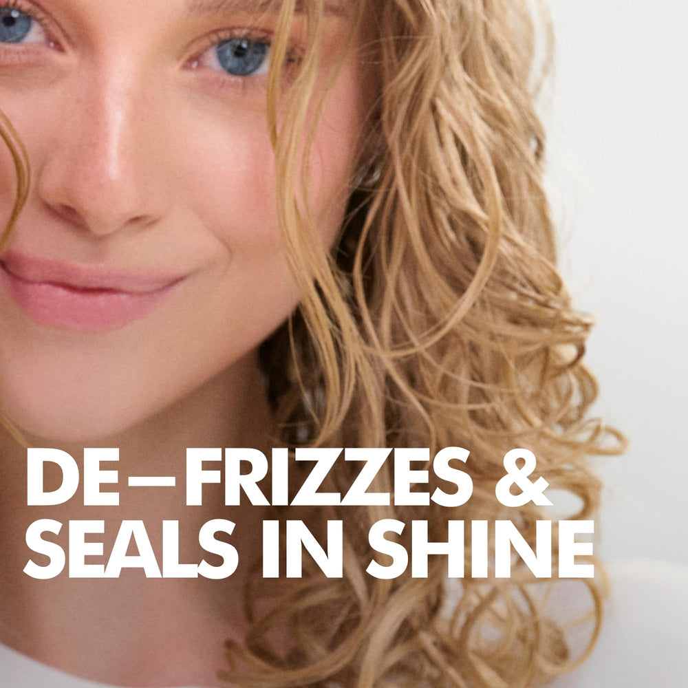Umberto Giannini conditioner being applied to curls to detangle and hydrate