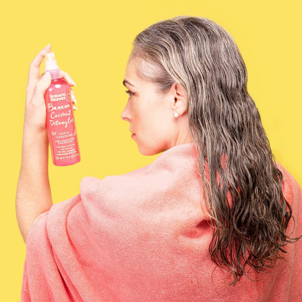 Umberto Giannini in hand for scale showing portable 8.4 fl oz travel-friendly size