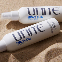 UNITE BEACH Day bottle in hand showing 8oz scale and travel-friendly size