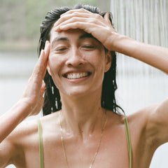 Ursa Major conditioner in use rinsing through hair for detangling and shine