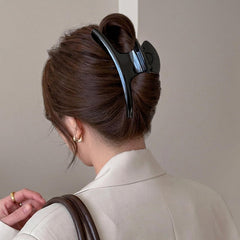 UVANKAUP held in hand for scale to show 6-inch size and capacity for thick hair