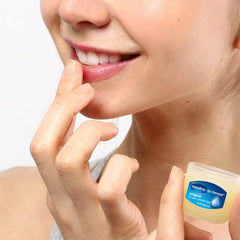 Applying Vaseline to lips for lasting softness and chapped-lip relief