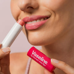 Bedside Vaseline sticks on nightstand conveying overnight lip care convenience