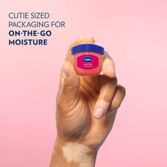 Hand applying Vaseline Rosy Lips on lips for instant smoothing and sheen