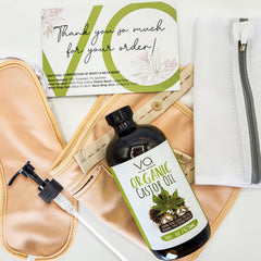 VITAL AFFAIR bottle and wrap in hand for scale, shows travel-friendly size