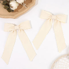 VOBOBE lifestyle portrait outdoors showing neutral bow elevating everyday outfits
