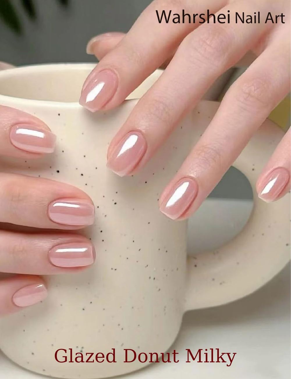 Hand model wearing Wahrshei glazed donut pink nails demonstrating salon-quality shine