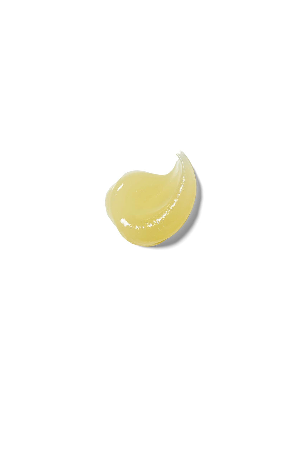 Weleda lip butter next to a coin to show small size and easy portability