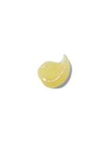 Weleda lip butter next to a coin to show small size and easy portability