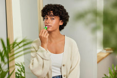 Weleda lip butter texture closeup highlighting creamy botanical sheen for smooth lips