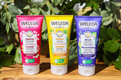 Weleda bottle beside a travel bag highlighting compact, travel-friendly size