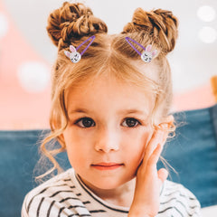 Wingchold clip fastened in child's hair showing secure hold and charm