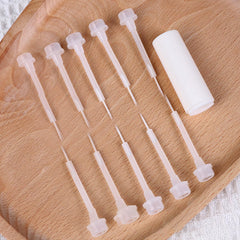 WOKOTO brushes beside hand for size comparison, illustrating compact portability