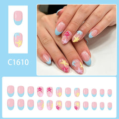WUHCIM close-up of short oval blue French tips highlighting neat salon look