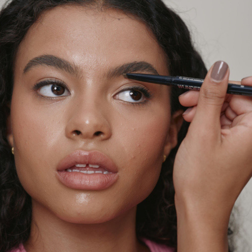 WUNDERBROW dual pencil held in hand to show compact travel-ready scale