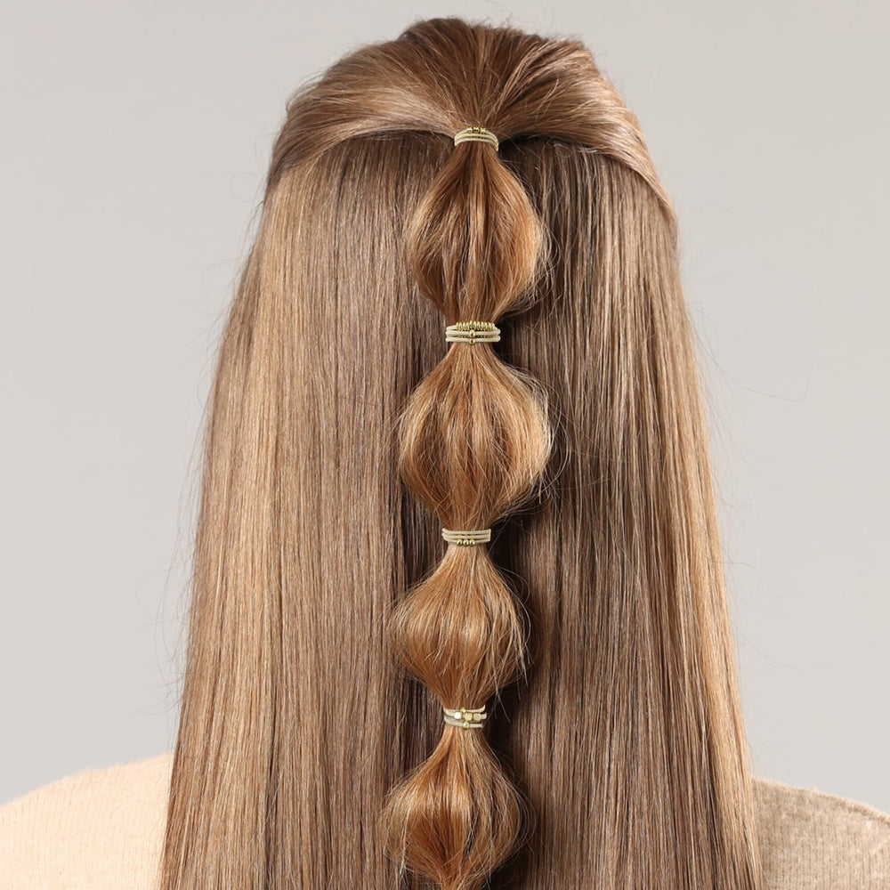 WY LIGHTING LEVEL hair tie next to ruler demonstrating compact size and travel benefit