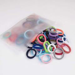 XIMA hair tie next to coin to show 1.5-inch diameter and scale benefit