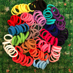 XIMA hair tie beside ruler showing 1.5-inch diameter for sizing