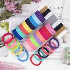 XIMA hair tie stretched between fingers showing strong large stretch