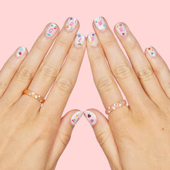 xo, Fetti application scene with tweezers placing a sticker for quick kid-friendly use