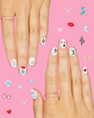 xo, Fetti sticker sheet next to a hand showing scale and easy selection of small decals