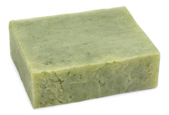 Yellow Bird soap held in hand to show scale and travel-friendly size