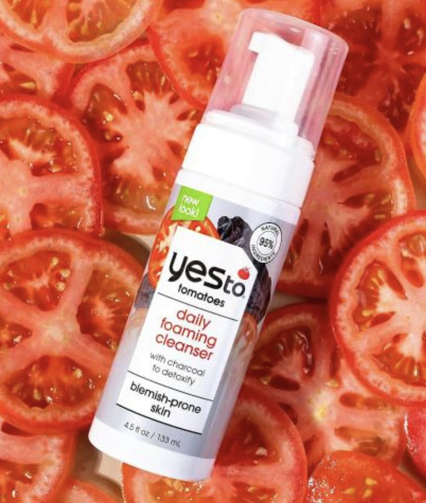 Yes To Tomatoes bottle next to measuring spoon for scale and travel-friendly 4.5 fl oz size
