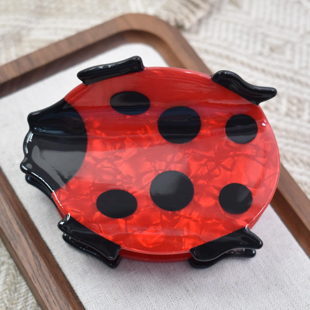 Ynxee ladybug side profile displaying spring mechanism and durable construction benefit