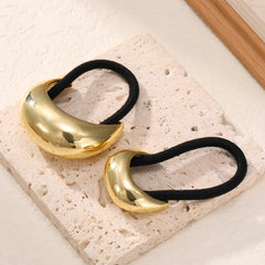 Yougeigy hair cuff beside a coin showing compact size and portability
