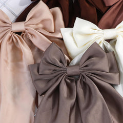 YWAOAIJD brown bow clipped in low ponytail for polished, long-wear hold