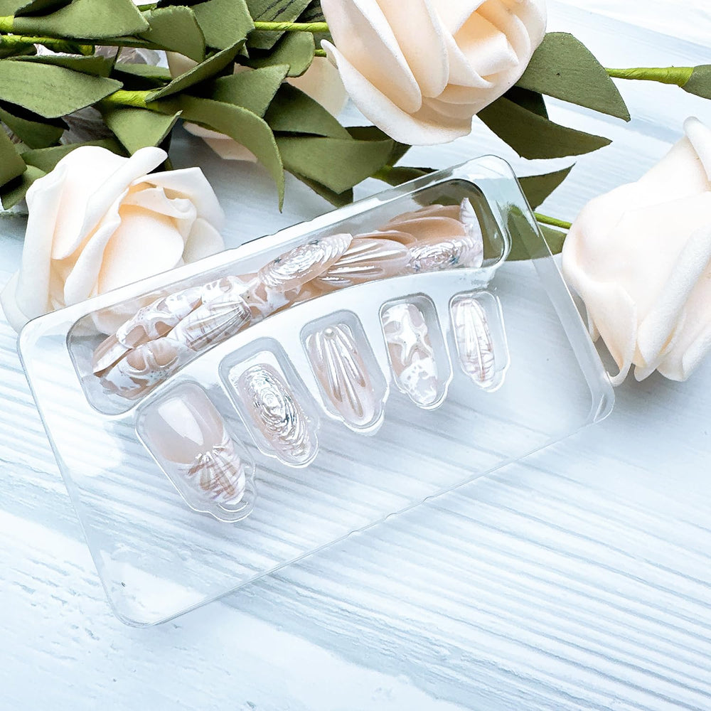 ZASKHLD hands applying press-on nail with adhesive tab for fast secure fit