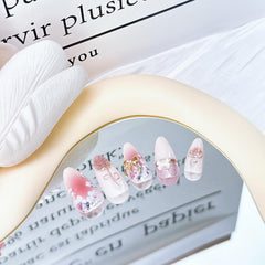 ZASKHLD nails on hand scale demo showing medium almond shape and fit
