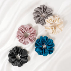 Zenssia scrunchie beside a coin to show size and travel-friendly convenience