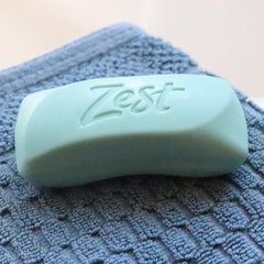 Zest bar size next to hand illustrating compact travel-friendly benefit