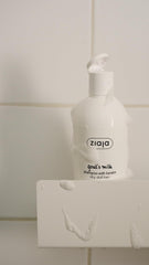 Ziaja shampoo bottle on bathroom shelf next to towel, lifestyle scene indicating easy daily use