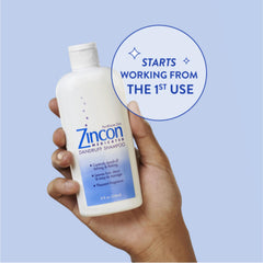 ZINCON bottle held in hand for size comparison showing 8 fl oz portability