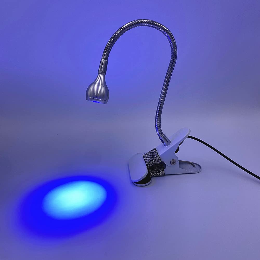 ZOELASS curing a Gel X nail tip to show precise curing of extensions