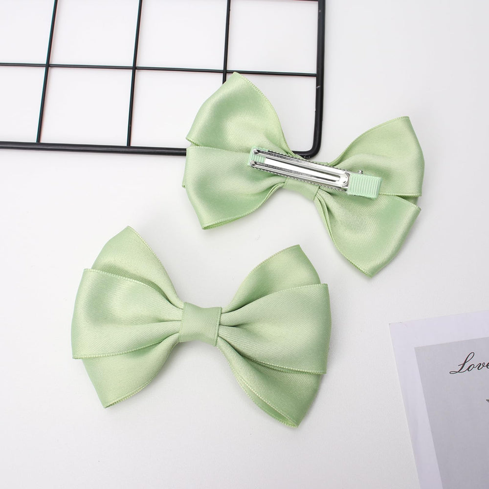 Zolyco double bow profile side emphasizing layered design and elegant silhouette