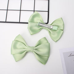 Zolyco double bow profile side emphasizing layered design and elegant silhouette