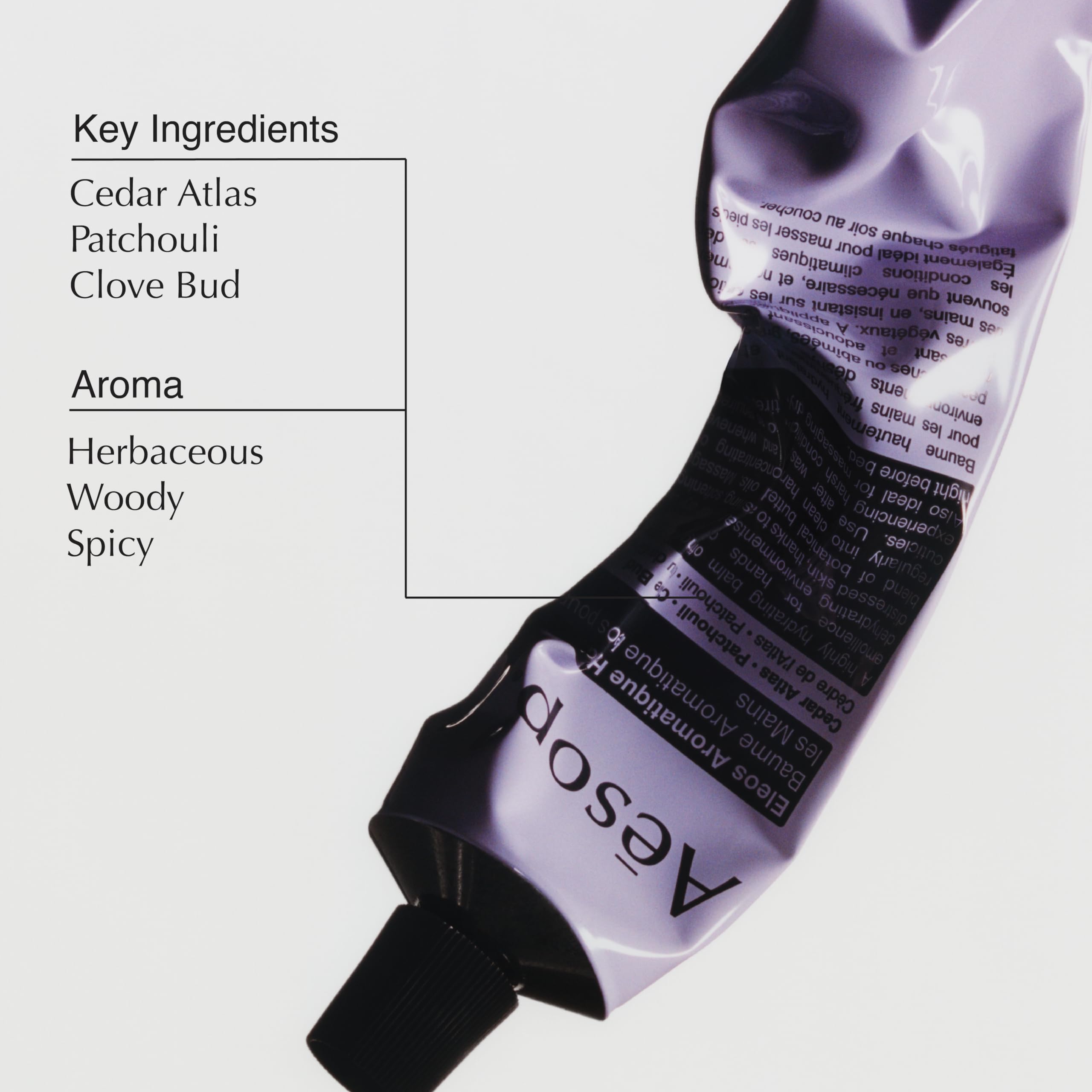 Aesop Eleos open cap with small drop demonstrating controlled application benefit