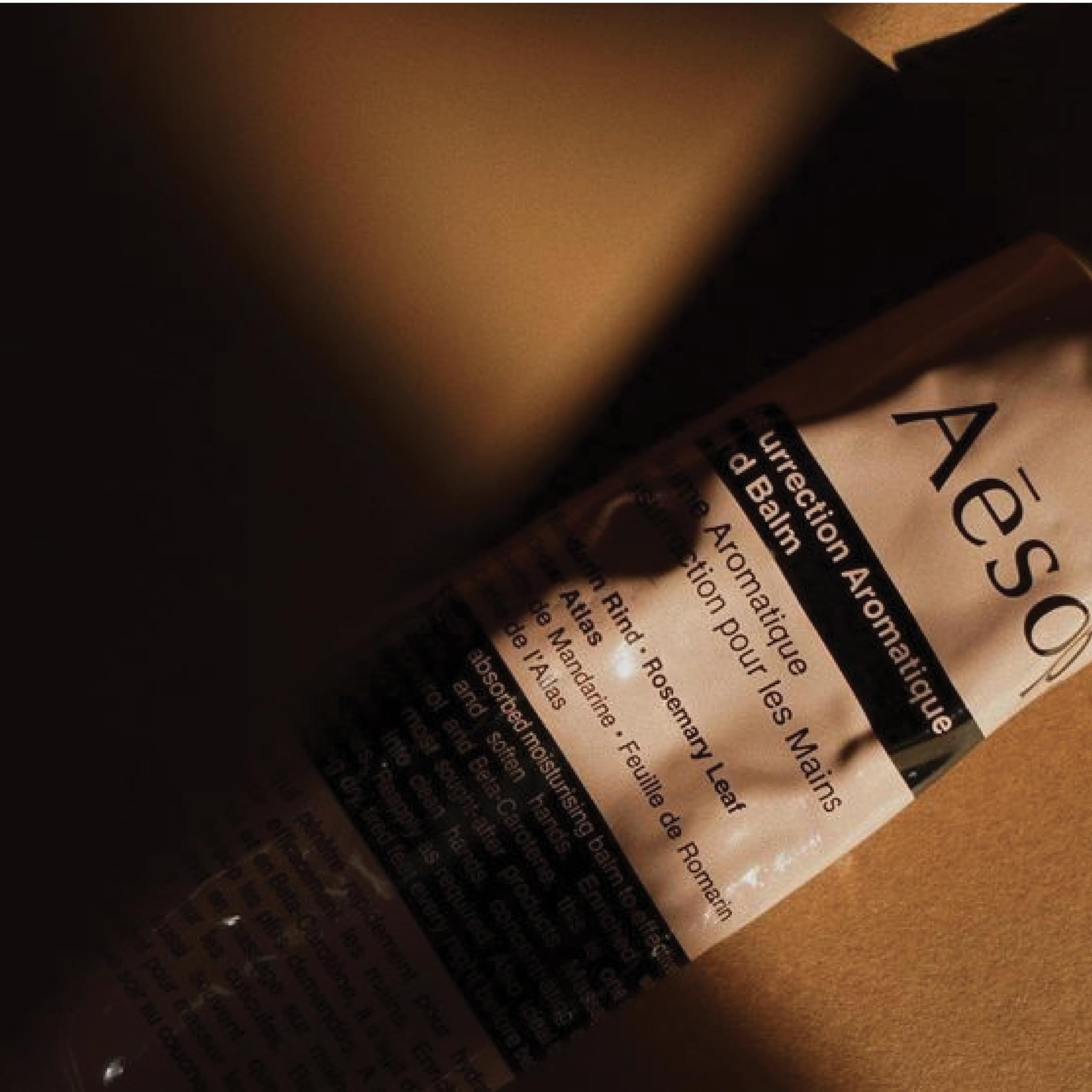 Aesop hand applying balm showing fast absorption and nourishment