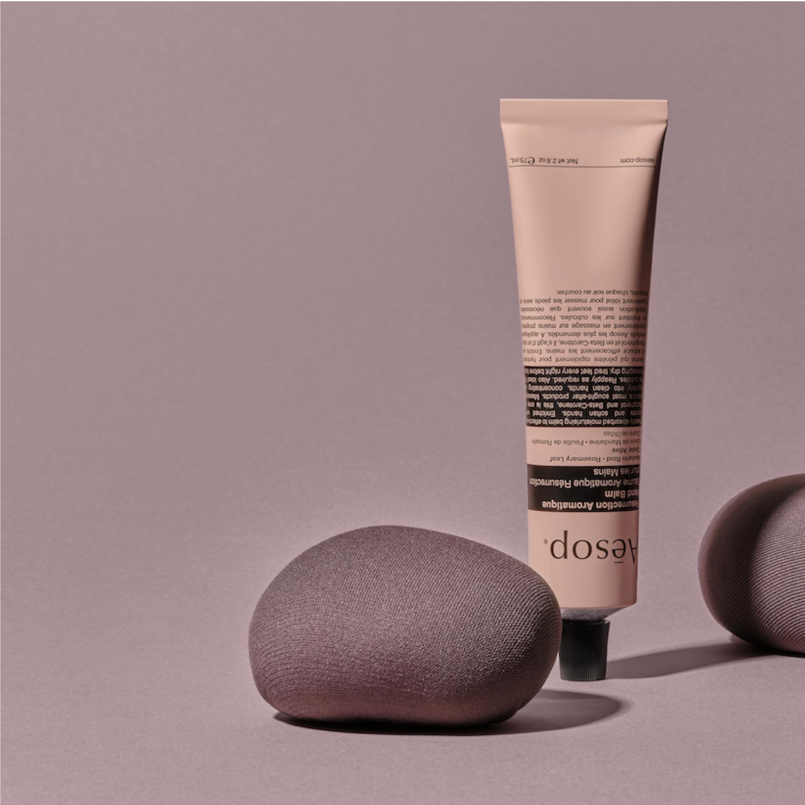 Aesop ingredients flatlay with mandarin rind and rosemary accents