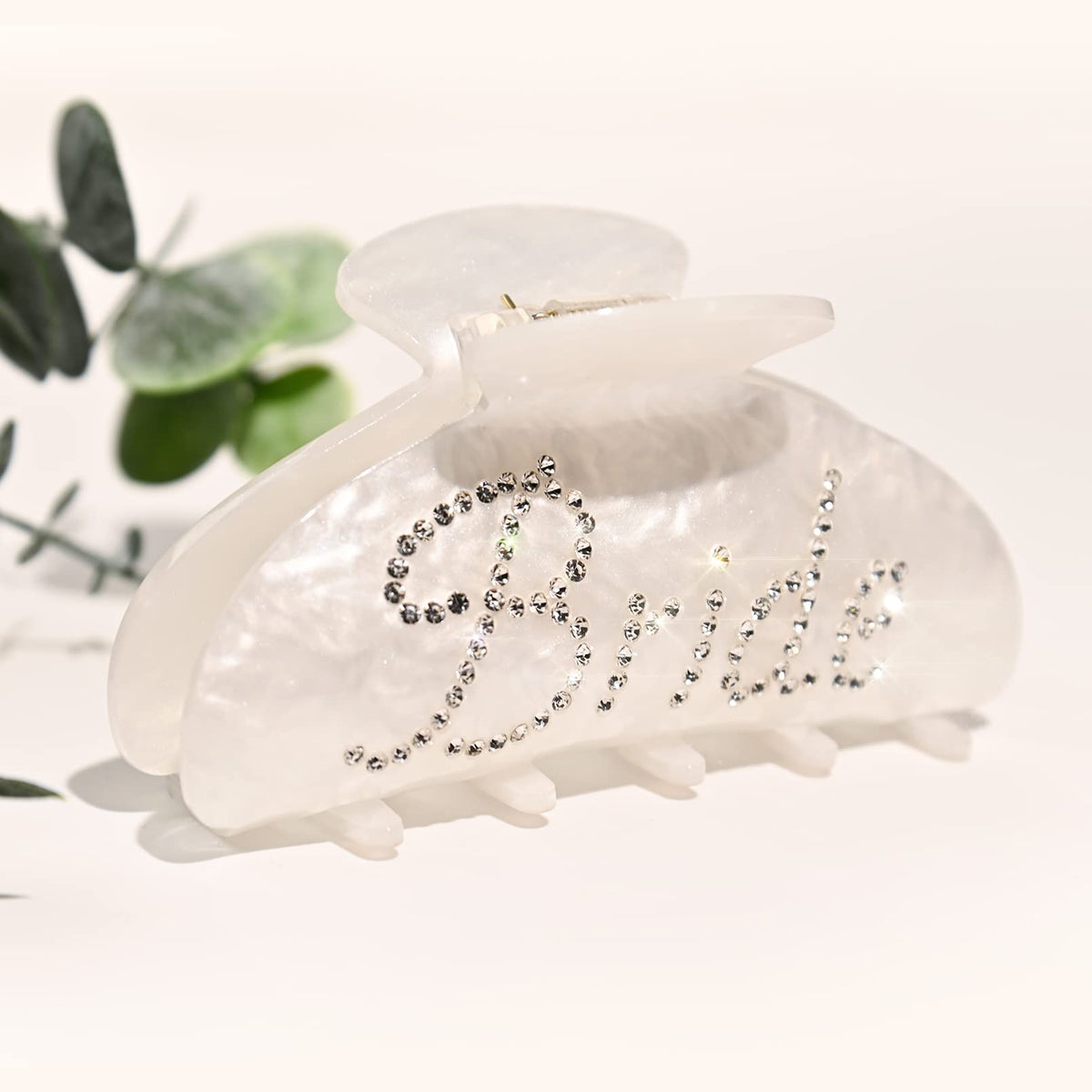 Aileam bride clip front view showing white acrylic and rhinestone elegance