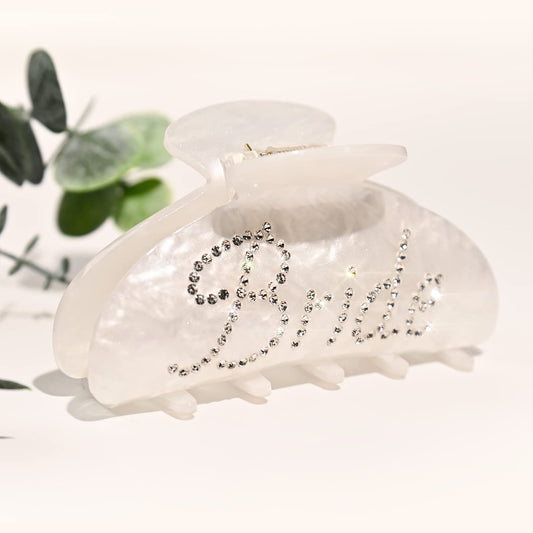 Aileam bride clip front view showing white acrylic and rhinestone elegance