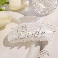 Aileam closeup of rhinestone bride logo highlighting sparkle for photos