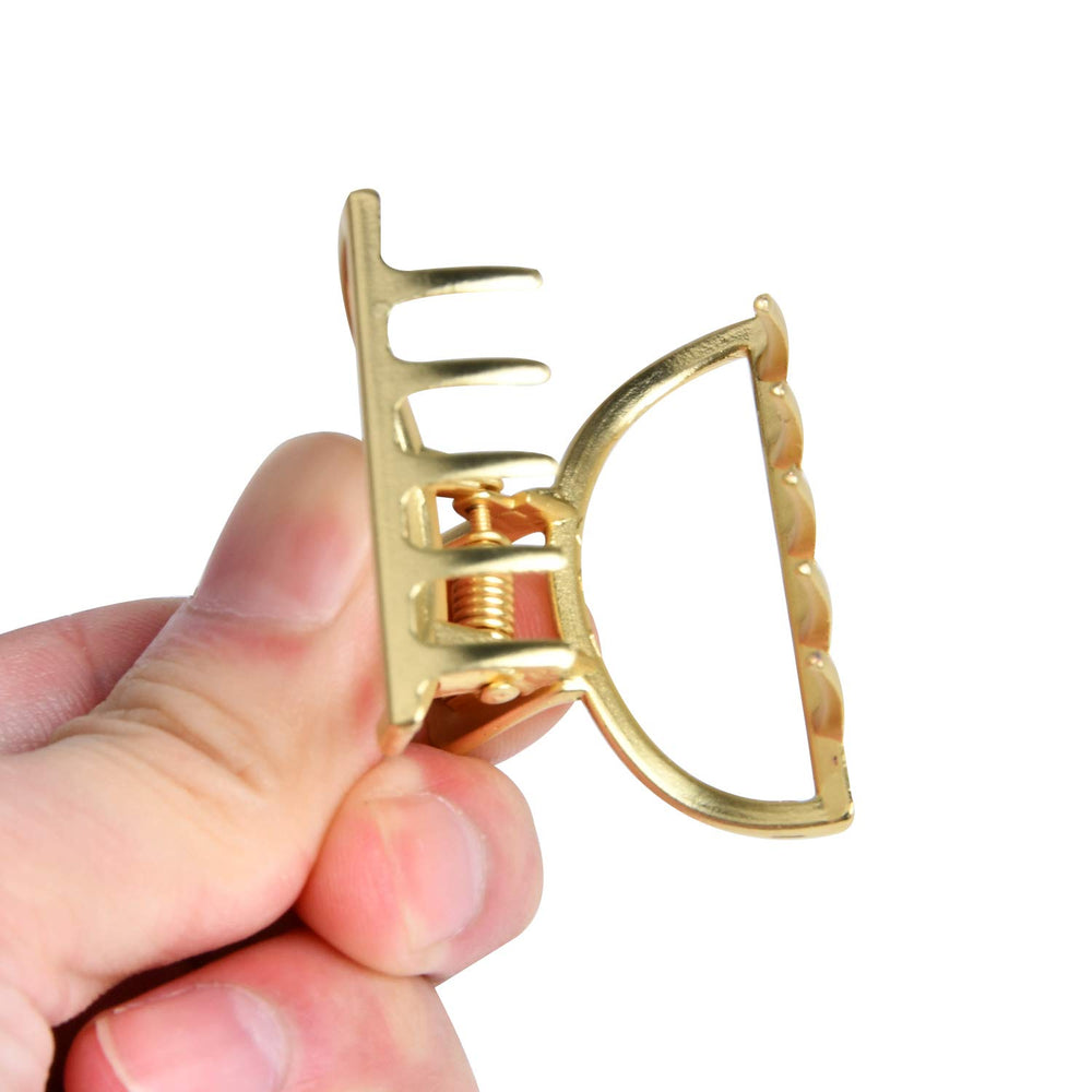 Akamino clip in a hand showing scale and small-size convenience for travel