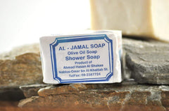 Close-up of Al-Jamal soap texture showing creamy olive-oil surface and gentle lather