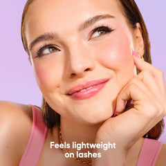 Almay mascara held in hand to show actual size and travel-friendly benefit