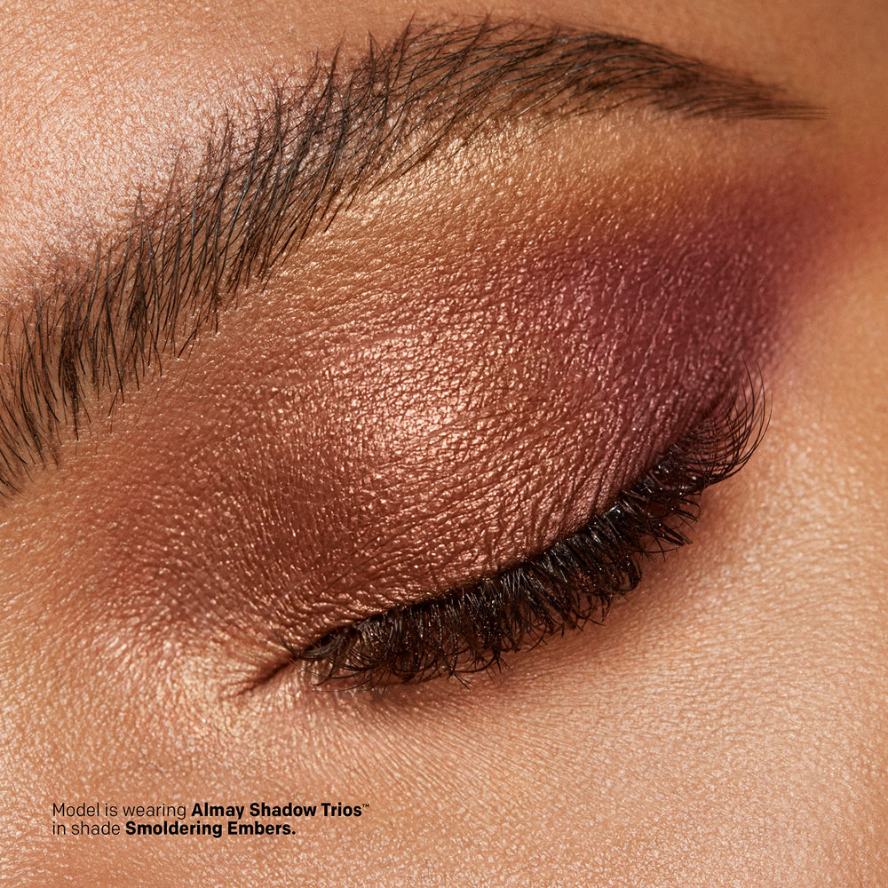 Almay palette next to fingers showing compact travel-friendly size
