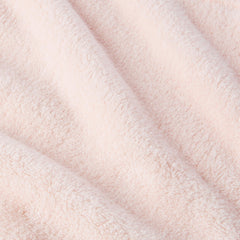 Amazon Basics towel wrap held in hand to show compact size and travel convenience